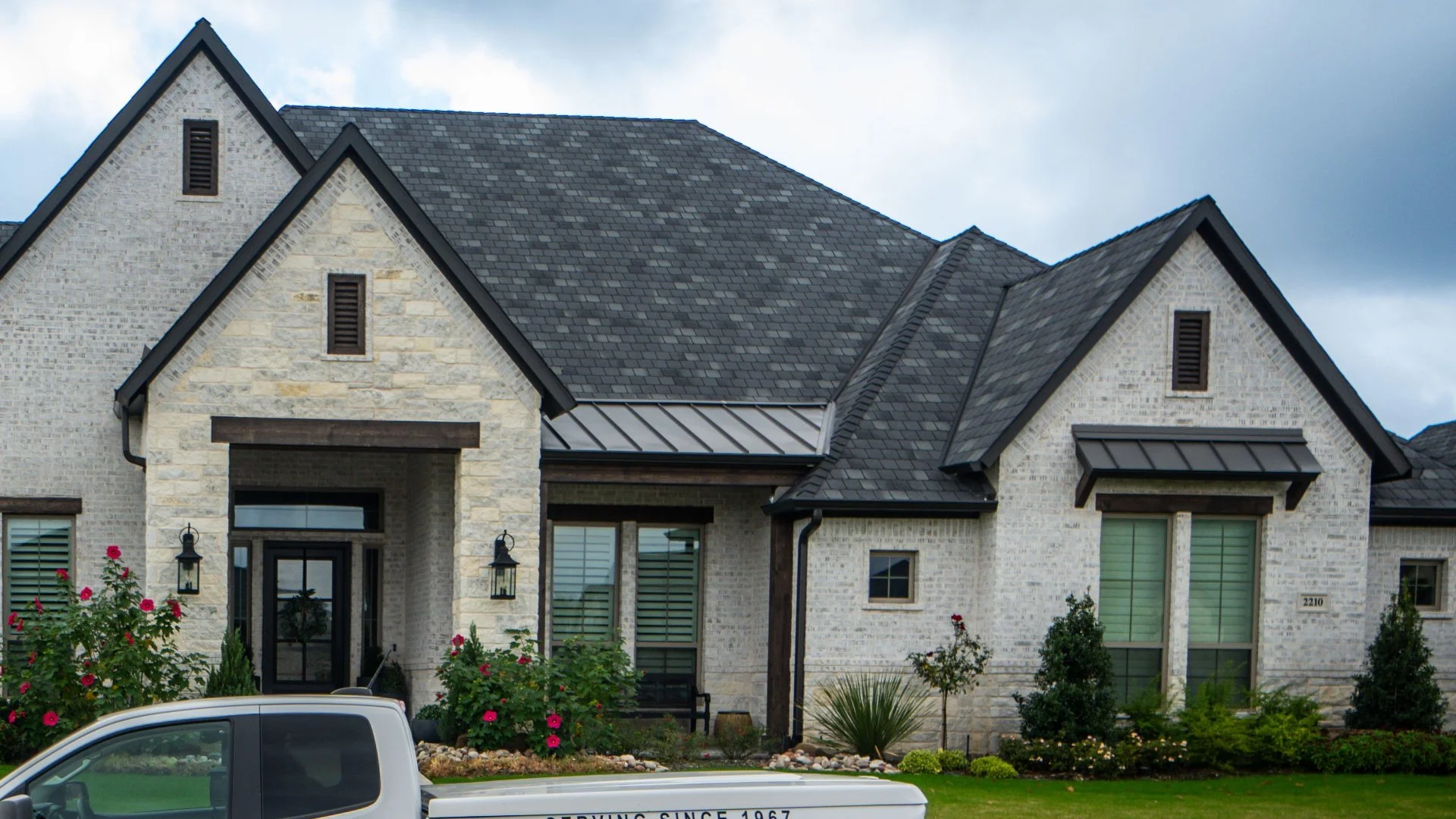 White stone house with beautiful landscaping in DeSoto, TX.