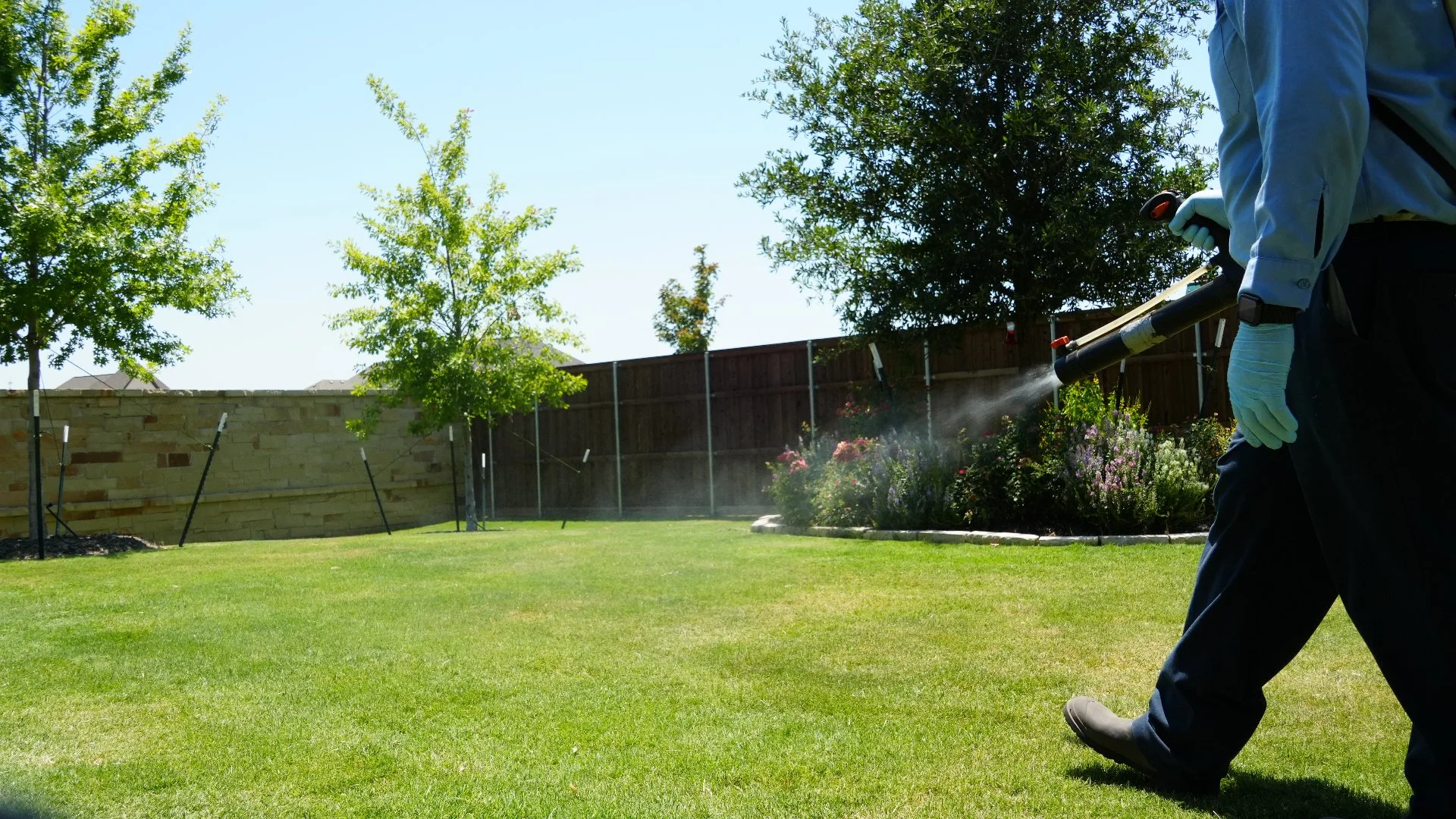 Worker using fogger to treat lawn in Richardson, TX.