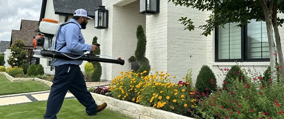 Landscape bed in Irving, TX, being treated with pest control treatment.