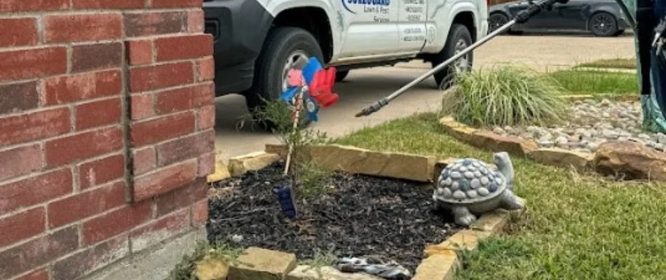 Perimeter pest control treatment being applied to a home in Godley, TX.