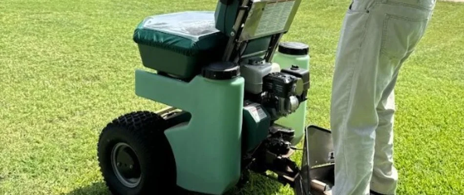 Worker applying a lawn care treatment in Arlington, TX.